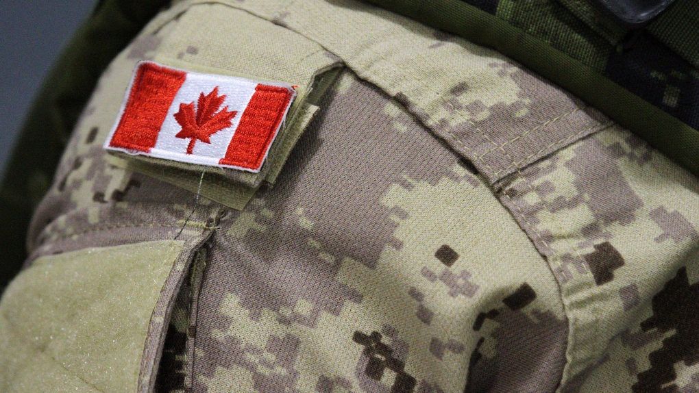 A Canadian flag sits on a member of the Canadian Armed Forces in this file photo. (Lars Hagberg/The Canadian Press)  