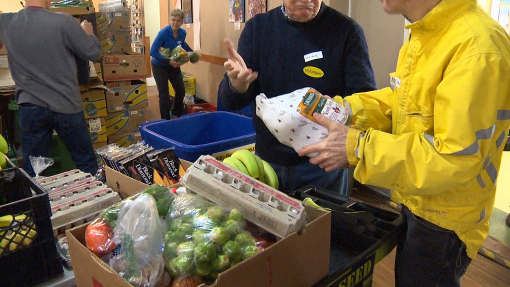 Volunteers work to create Christmas hampers for those in need at the Mustard Seed food bank in Victoria, Thurs., Dec. 15, 2016. (CTV Vancouver Island)
