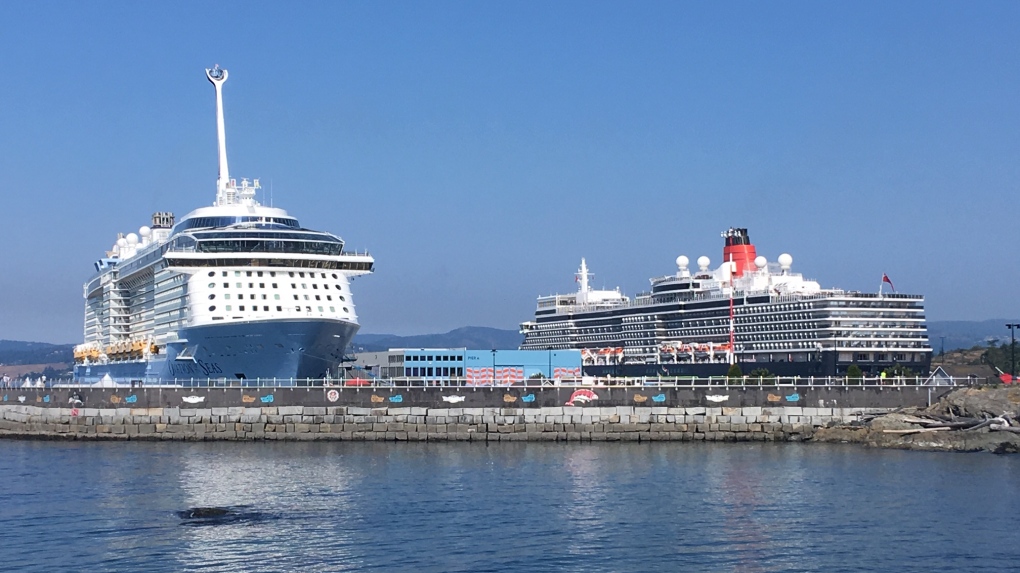 The Queen Elizabeth cruise ship (right) is docked alongside the Ovation of the Seas at Victoria's Ogden Point on Thursday, May 30, 2019. (CTV Vancouver Island)