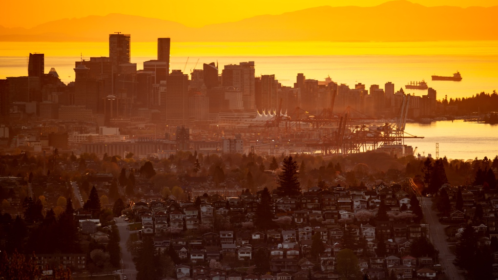 The downtown Vancouver skyline is seen at sunset, as houses line a hillside in Burnaby, B.C., on Saturday, April 17, 2021. THE CANADIAN PRESS/Darryl Dyck 
