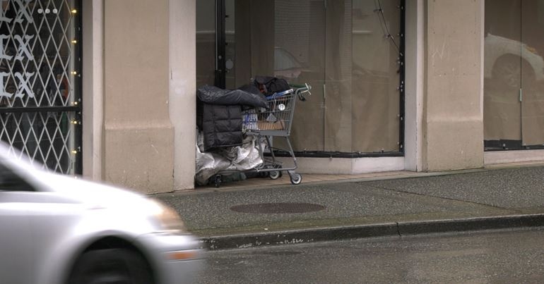 A person seeks shelter in doorway on Victoria’s Johnson Street on Jan. 11, 2022. (CTV News)