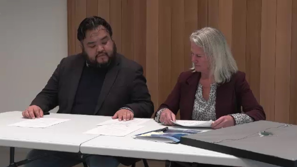 Tsartlip First Nation Chief Don Tom and interim BC Ferries president and CEO Jill Sharland sign the protocol agreement. (CTV News)