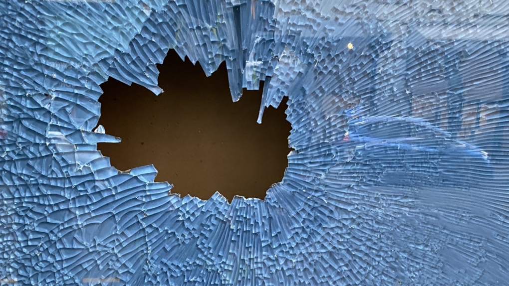 A vehicle is reflected in broken glass in downtown Victoria in this photo shared by VicPD.