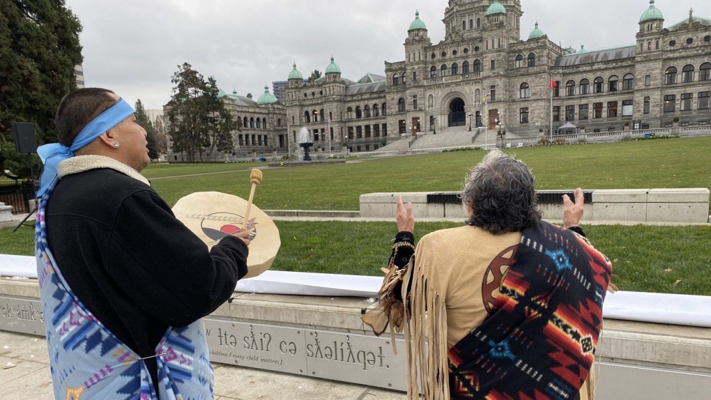 Elder Mary Ann Thomas and Charlie George, of the B.C. Association of Aboriginal Centres, welcome the new Indigenous signage unveiled on the grounds of the B.C. legislature, once the site of an Indigenous village, in Victoria on Wednesday Nov. 29, 2023. THE CANADIAN PRESS/Dirk Meissner