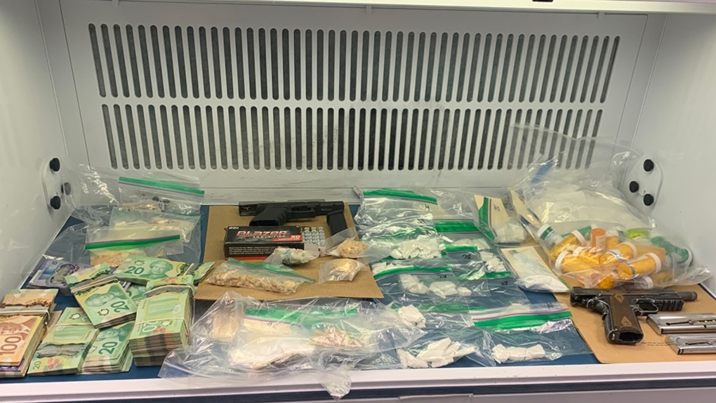 Victoria police say they seized handguns, drugs, cash and a stolen bicycle worth $10,000 in a pair of searches earlier this week. (VicPD)