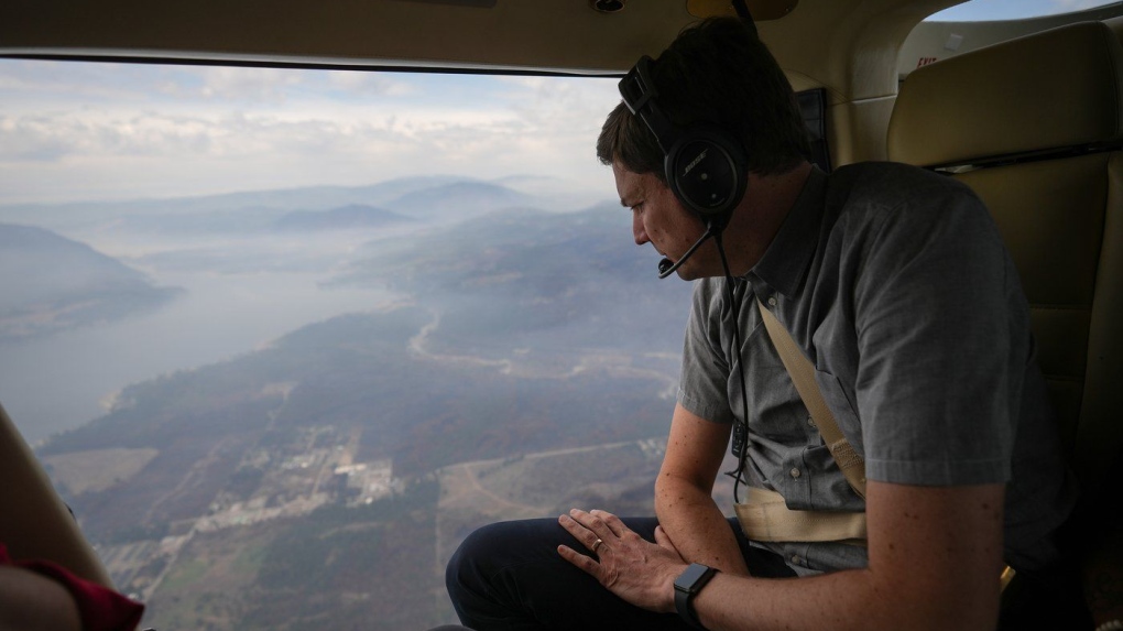 B.C. Premier David Eby looks out at Scotch Creek, B.C., while viewing areas of the Shuswap affected by the Bush Creek East wildfire on a helicopter flight from Kamloops to Salmon Arm, on Monday, Sept. 11, 2023. THE CANADIAN PRESS/Darryl Dyck
